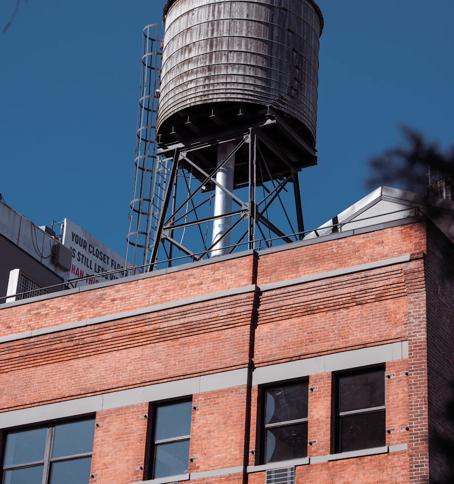 Water tower on top of a brick building