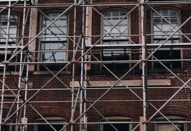 Brick building elevation with rows of windows, surveyed joint by joint before repointing