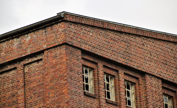 Older brick building facade with rows of windows