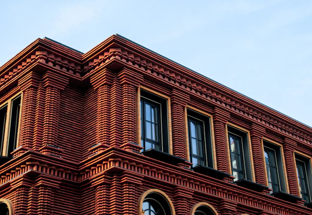 Red brick facade with rows of windows, each opening mapped against the facade report before lintel work starts