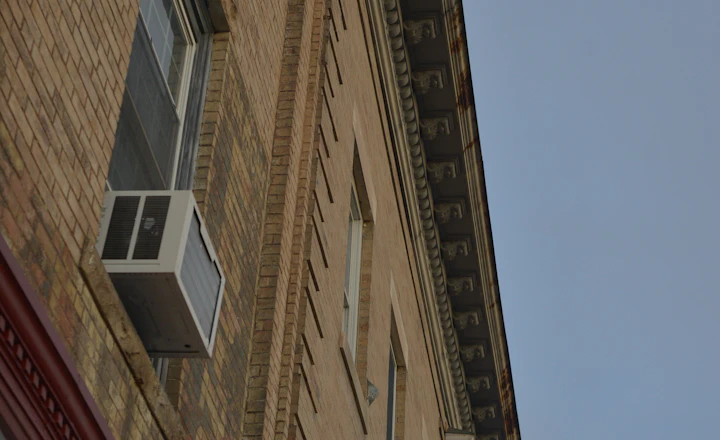 Brick building facade with windows and mortar joints that need repointing