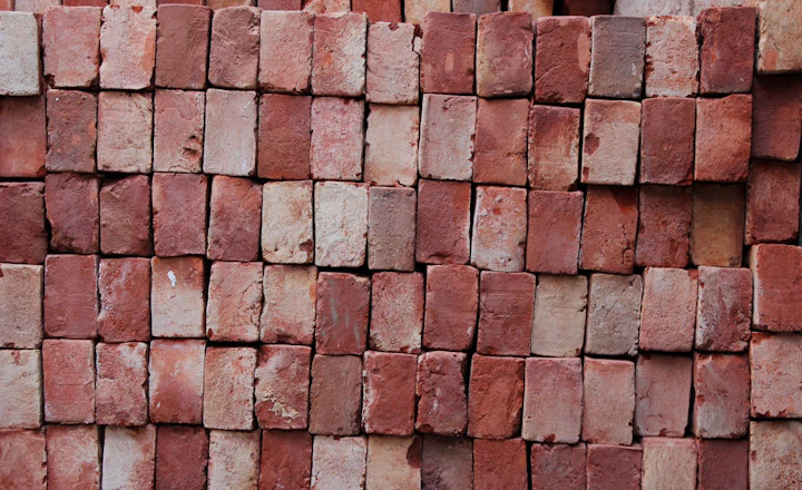 Close-up of a brown brick wall and its mortar joints