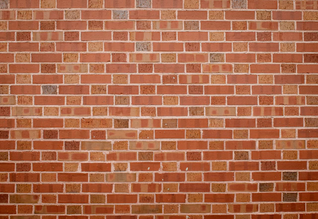 Clean red brick wall with even mortar joints