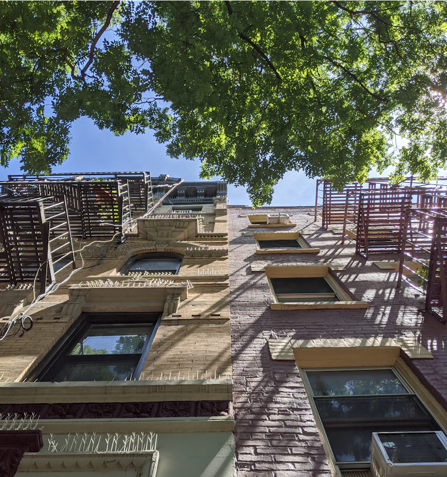 Tall brick apartment building with rows of windows