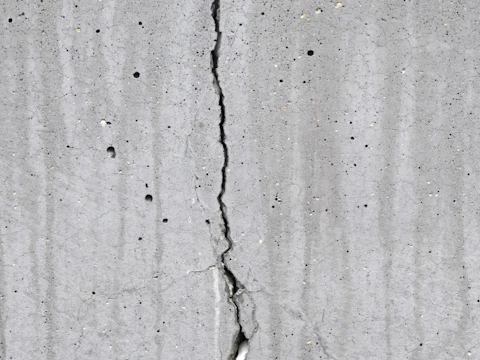 Crack running through weathered concrete on a building
