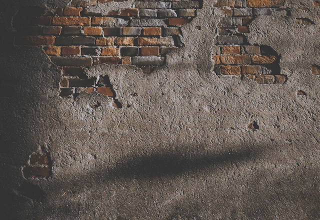 Wall with broken bricks opened up, where the condition of the ties behind can be checked