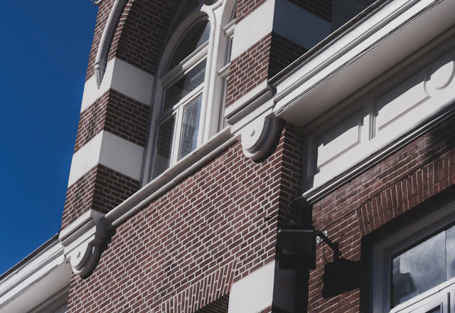 Ornate brick building facade against a clear blue sky