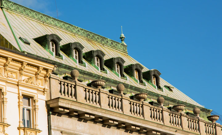Ornate building roofline with cornice, parapet, and dormer windows