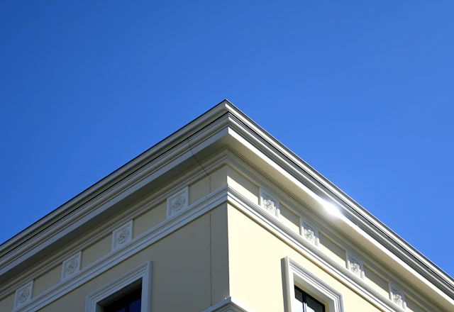 Cream building facade with clean decorative molding after restoration
