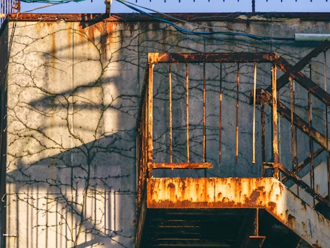 Heavily rusted fire escape on a weathered building