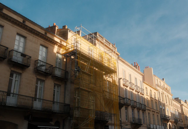 Building facade with scaffolding set up for a unit-by-unit terra cotta sounding survey