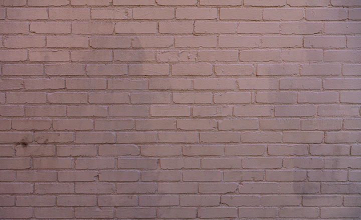 Weathered brick wall with worn mortar joints