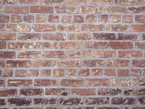 Close view of a weathered brick wall and its mortar joints