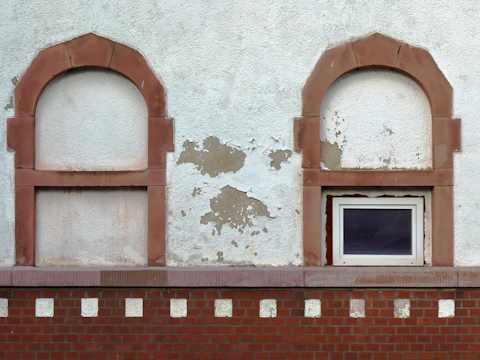White-framed window set in a brown brick wall